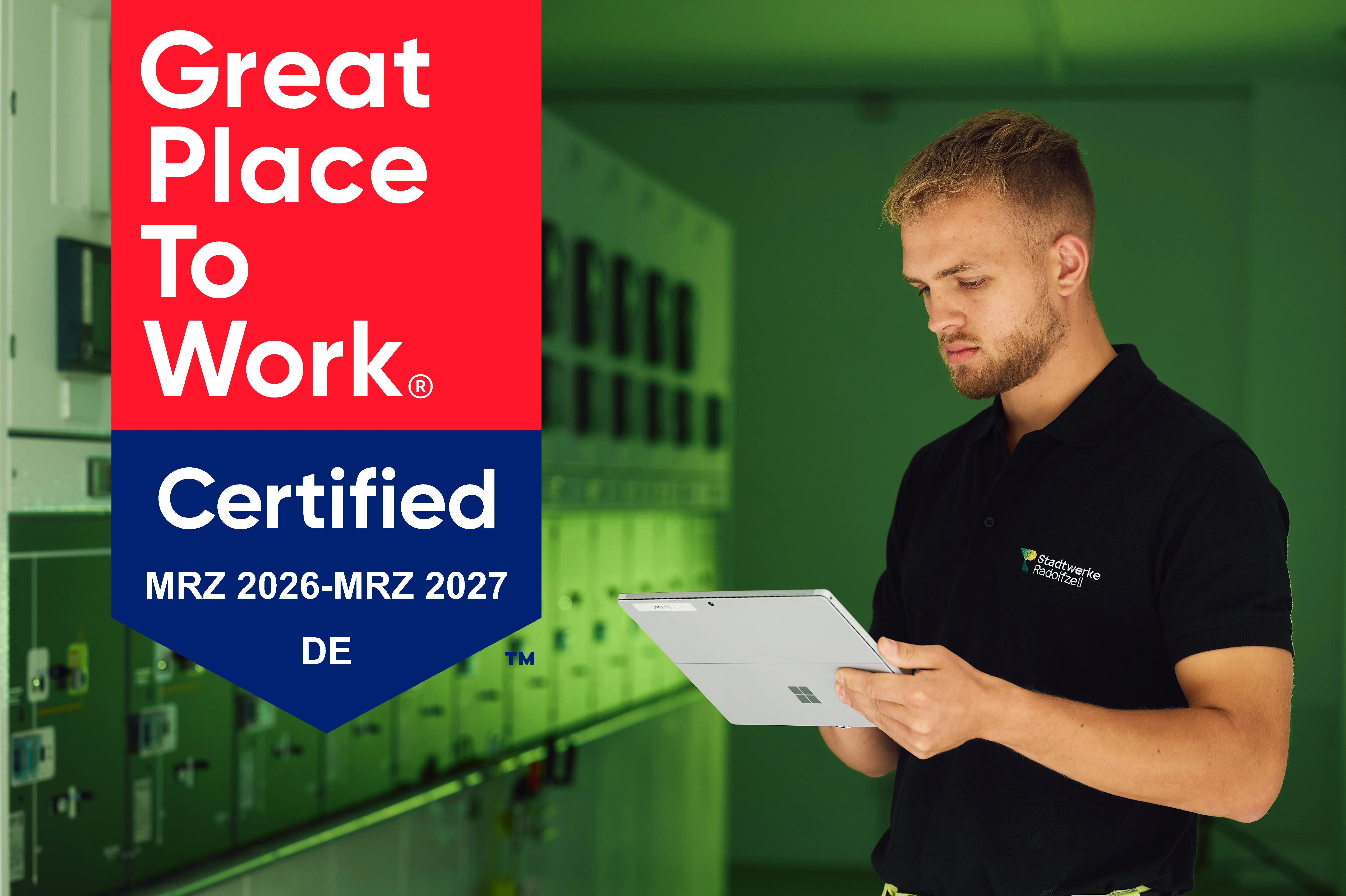 Ein Mitarbeiter mit Tablet in einem Büroumfeld, der eine Great Place to Work Zertifizierung für MRZ 2026 bis MRZ 2027 in Deutschland zeigt.